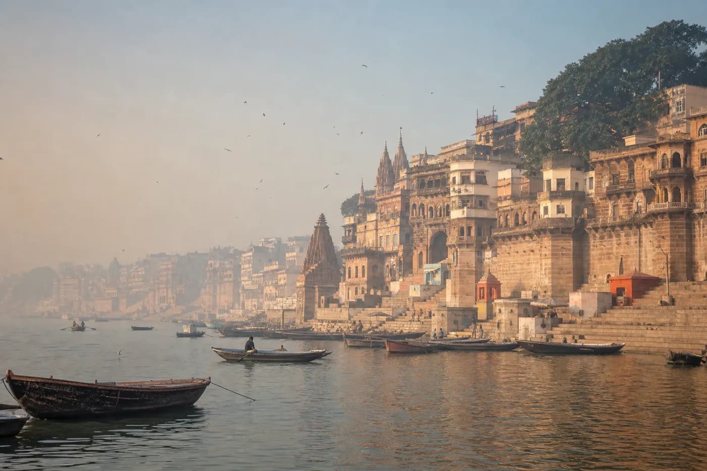 Morning light over boats and historic riverside ghats in Varanasi